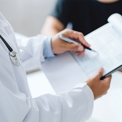 Close up of a doctor writing on a clip board