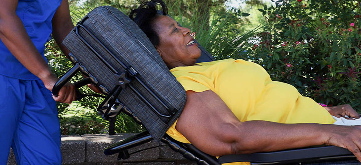 A woman in a reclined wheelchair position