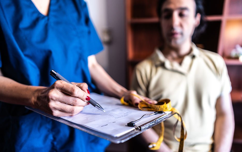 A clinician documenting patient measurements