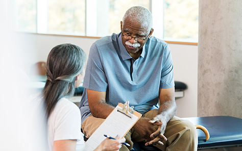 Medical professional discussing a seating assessment with the patient