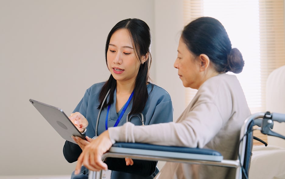 A nurse going over options with patient in wheelchair.