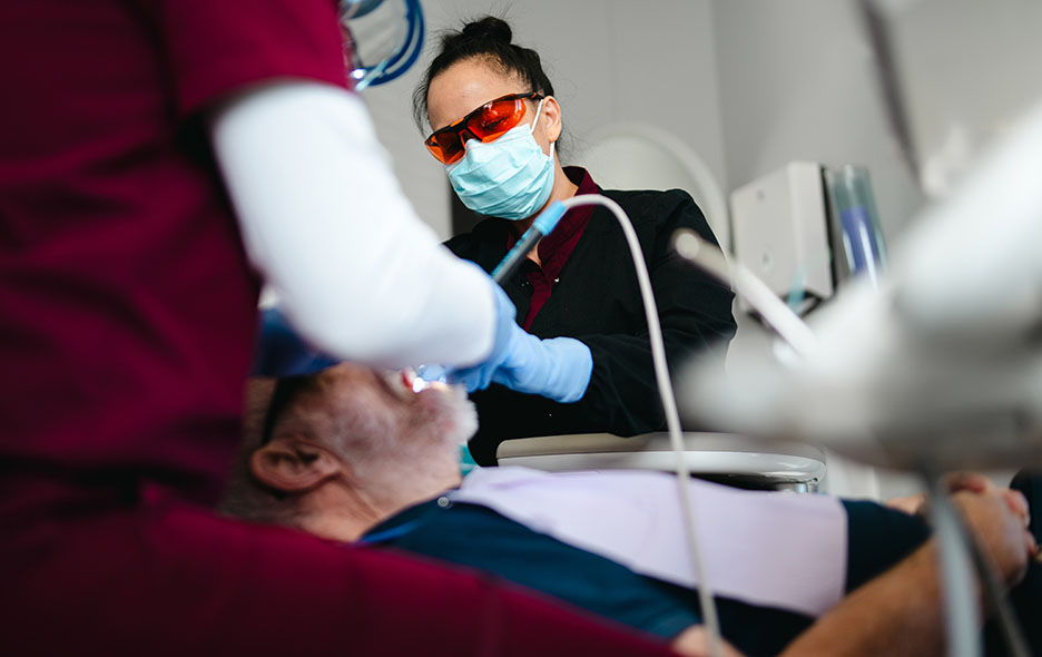Dentist and assistant working on a patient