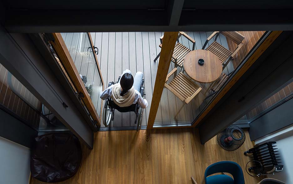 An overhead photograph of a person using a wheelchair throughout their home