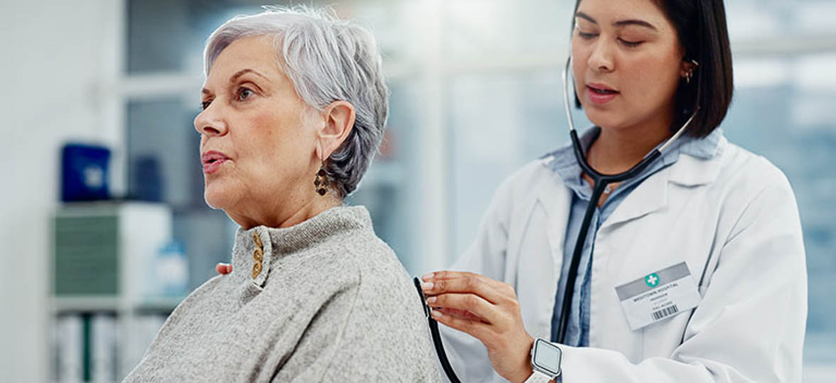 Doctor Listening to Patient's Heart With A Stethoscope