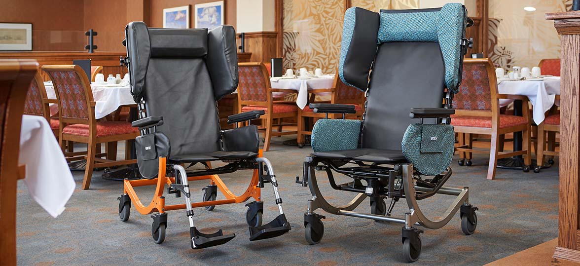 Two Encore wheelchairs by Broda in a large dining setting